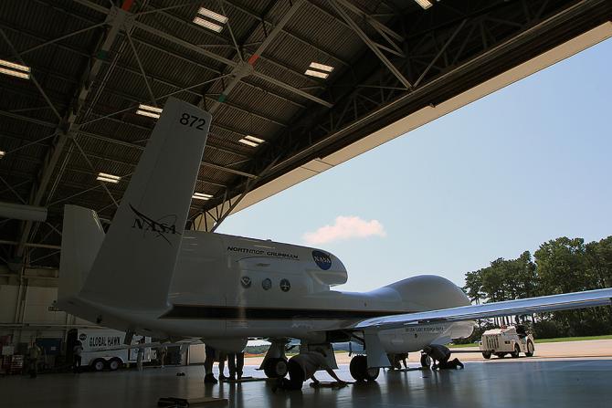 Technicians securing NASA's Global Hawk unmanned aircraft in the aircraft hangar